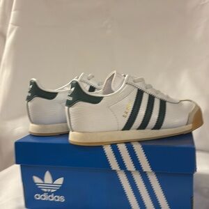 Kids Adidas size 10 shoes with hunter green stripes